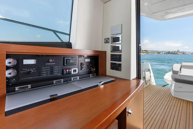 Slide: The Image of Prestige 550 yacht interior with control panel, overlooking ocean view, 2016 model. - 27