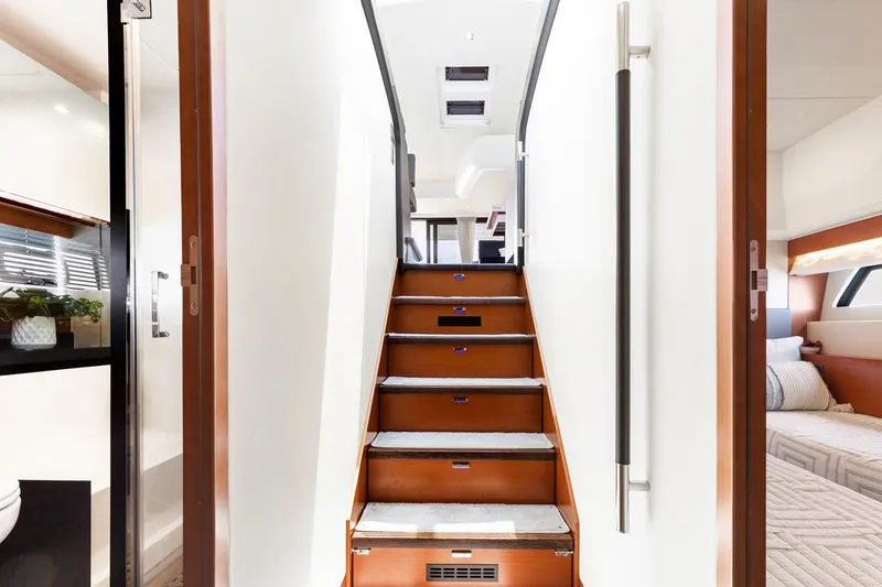 Slide: The Image of Interior staircase of 2016 Prestige 550 yacht, featuring modern design and wood accents. - 28