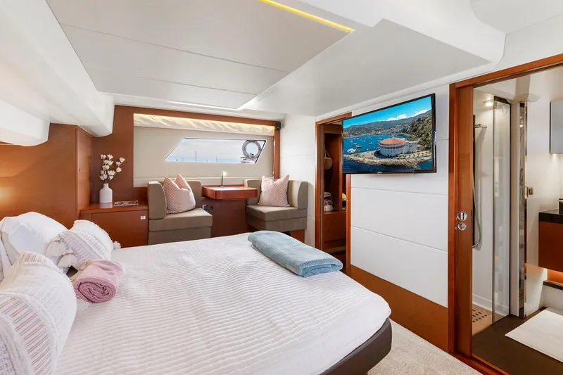 Slide: The Image of Luxurious 2016 Prestige 550 yacht bedroom with modern decor and scenic window view. - 30