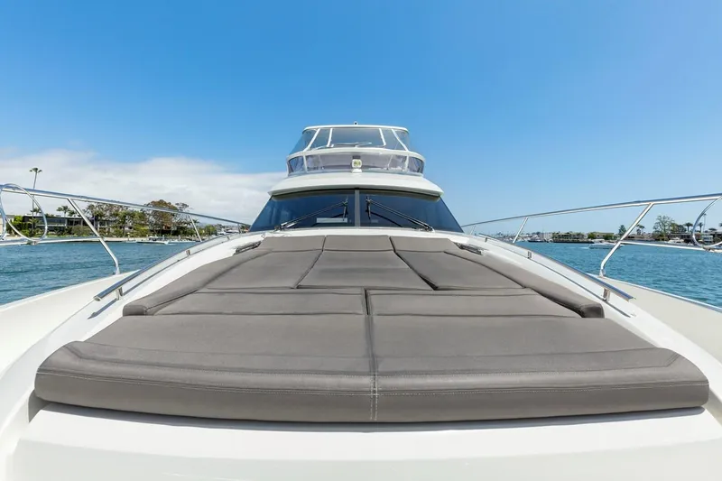 Slide: The Image of Prestige 550 yacht 2016 model, featuring spacious sun deck on calm waters. - 4