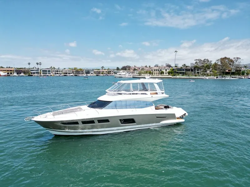 Slide: The Image of 2016 Prestige 550 yacht cruising on a sunny day in a scenic harbor. - 43