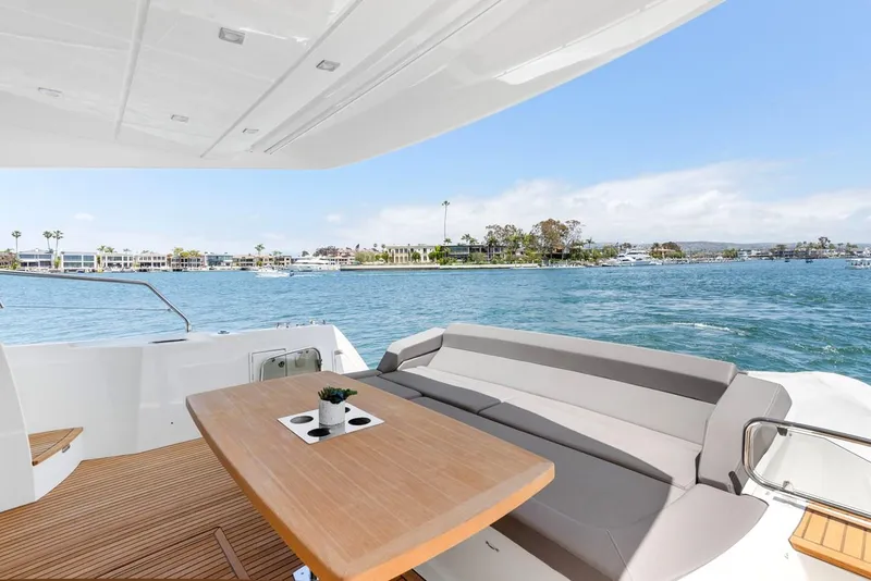 Slide: The Image of Luxury 2016 Prestige 550 yacht with spacious deck and scenic waterfront view. - 7