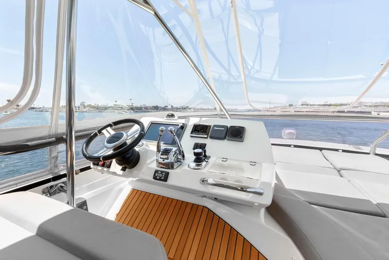 Slide: The Image of Prestige 550 yacht helm, 2016 model, featuring sleek controls and ocean view. - 9