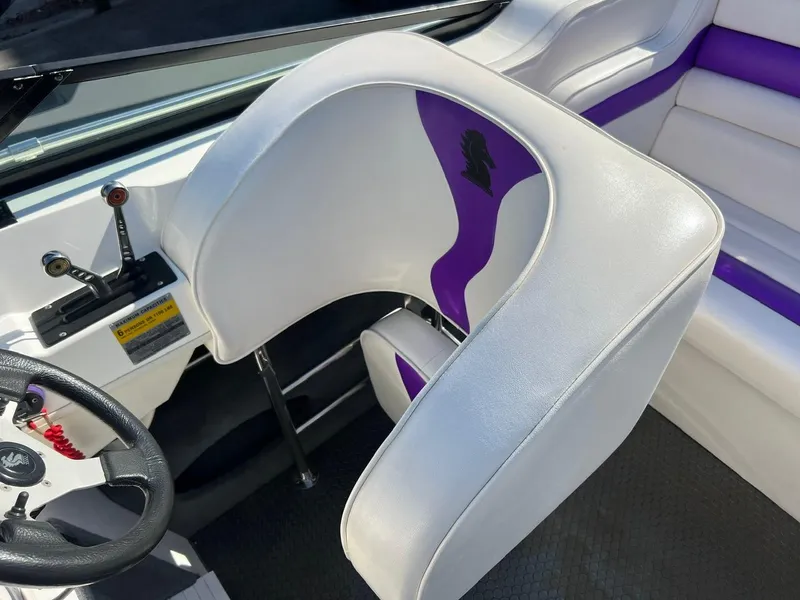 Slide: The Image of 1994 Checkmate 253 Convincor boat interior with white and purple seating. - 10