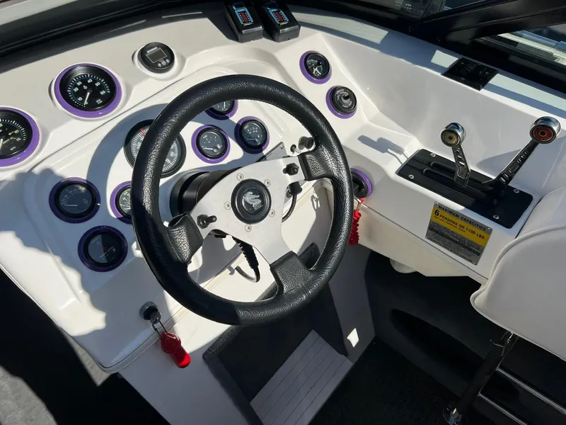 Slide: The Image of 1994 Checkmate 253 Convincor boat dashboard with steering wheel and gauges. - 11
