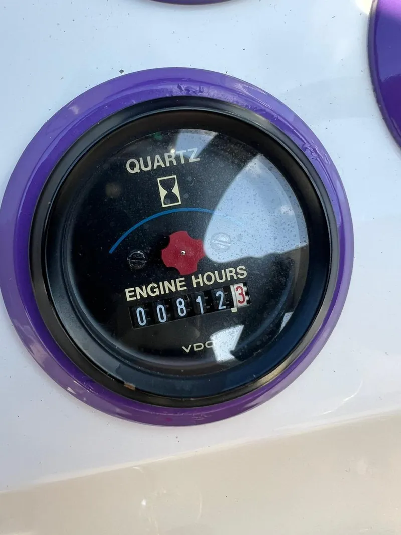 Slide: The Image of 1994 Checkmate 253 Convincor engine hour meter showing 812.3 hours. - 12