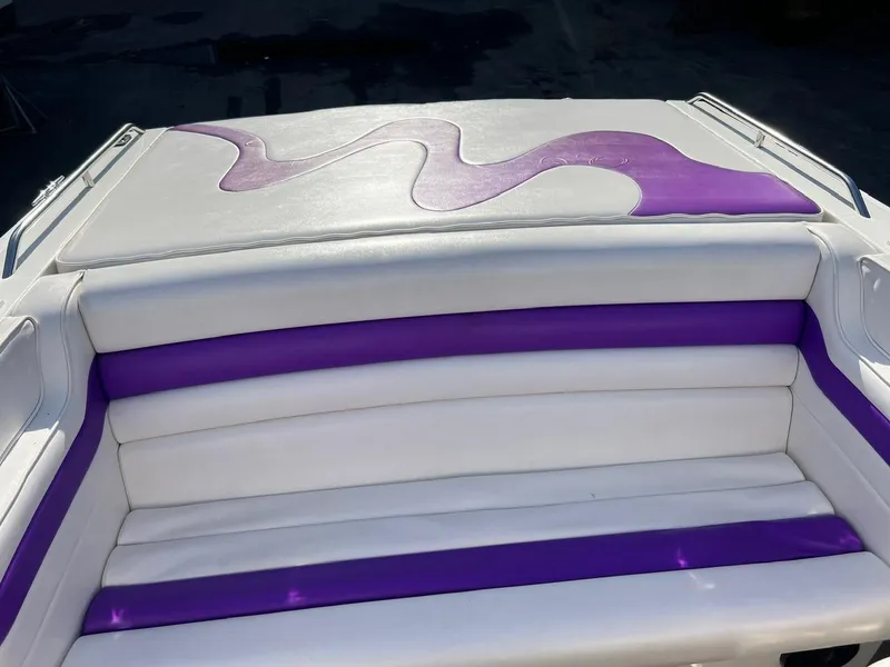 Slide: The Image of 1994 Checkmate 253 Convincor boat seat with white and purple upholstery design. - 20