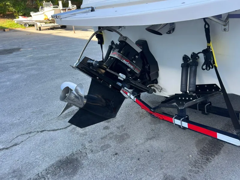 Slide: The Image of 1994 Checkmate 253 Convincor boat with visible propeller and trailer. - 4