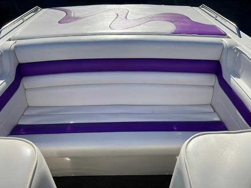 Slide: The Image of 1994 Checkmate 253 Convincor boat interior with white and purple seating. - 9