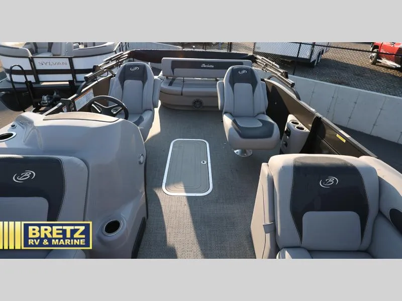 Slide: The Image of 2025 Aria Cast-N-Cruise A22CC boat interior with gray seating, showcased by Bretz RV & Marine. - 16