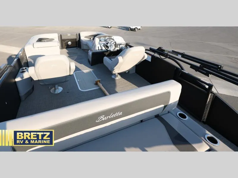 Slide: The Image of 2025 Aria Cast-N-Cruise A22CC boat interior with seating and steering wheel. - 21