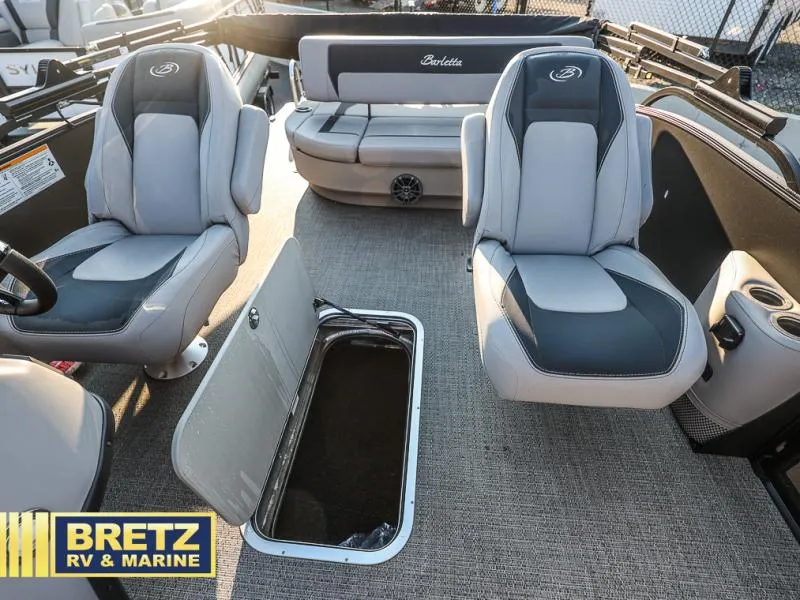 Slide: The Image of 2025 Aria Cast-N-Cruise A22CC boat interior with seating and storage, Bretz RV & Marine. - 25