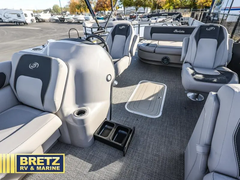Slide: The Image of 2025 Aria Cast-N-Cruise A22CC boat interior with gray seating at Bretz RV & Marine. - 26