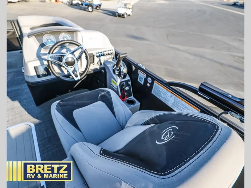 Slide: The Image of Interior of 2025 Aria Cast-N-Cruise A22CC boat with steering wheel and controls. - 28