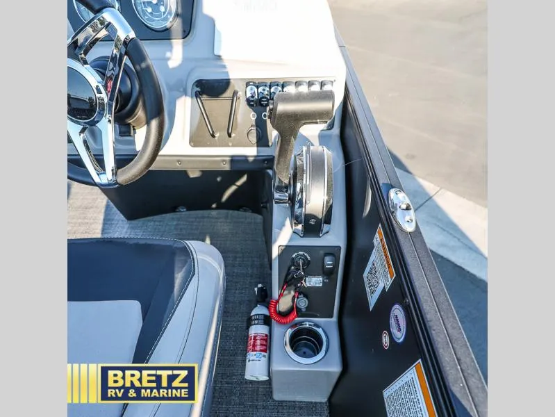 Slide: The Image of Interior of 2025 Aria Cast-N-Cruise A22CC boat with steering wheel and controls. - 29