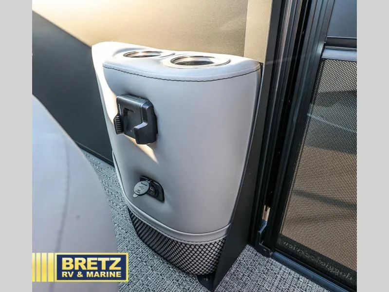 Slide: The Image of 2025 Aria Cast-N-Cruise A22CC interior cup holders and power outlet detail. - 34
