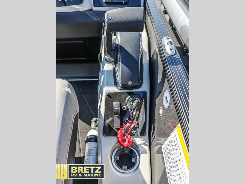 Slide: The Image of 2025 Cabrio Ultra-Lounge C24UC boat console with controls and cup holder. - 12