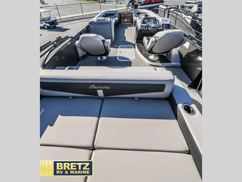 Slide: The Image of 2025 Cabrio Ultra-Lounge C24UC boat interior with plush seating and modern dashboard. - 9