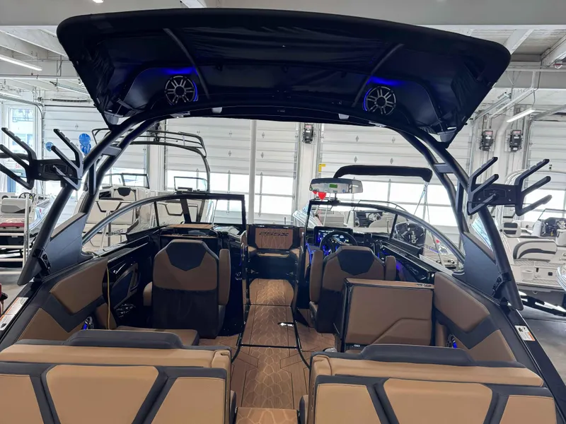 Slide: The Image of 2025 Yamaha Boats 255XD interior with modern seating and advanced features in a showroom. - 3