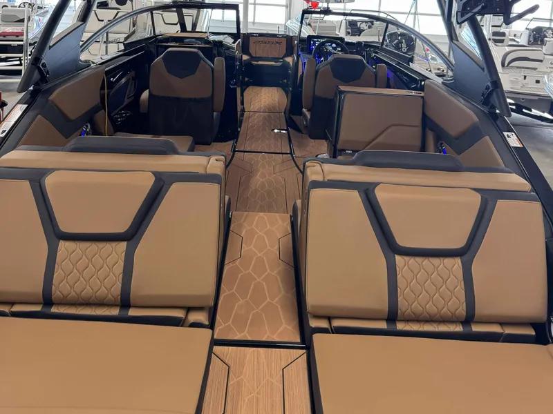 Slide: The Image of Interior of 2025 Yamaha Boats 255XD, featuring luxurious tan and black seating. - 4