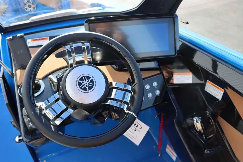 Slide: The Image of 2025 Yamaha Boats 222XD dashboard with steering wheel and touchscreen display. - 12