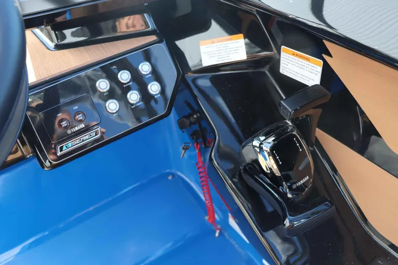 Slide: The Image of 2025 Yamaha Boats 222XD dashboard with controls and warning labels. - 14