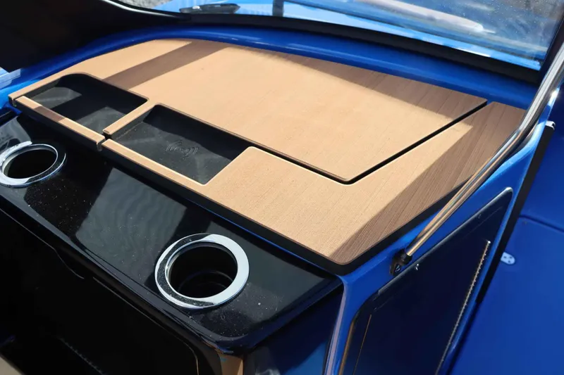 Slide: The Image of 2025 Yamaha Boats 222XD dashboard with cup holders and wooden accents. - 15