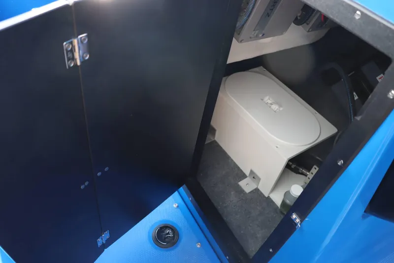 Slide: The Image of 2025 Yamaha Boats 222XD interior storage compartment with equipment. - 16