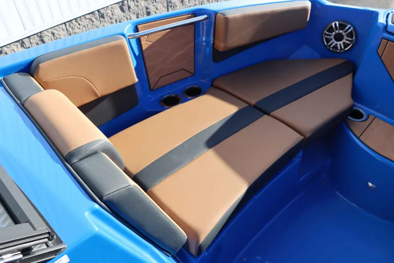 Slide: The Image of 2025 Yamaha Boats 222XD interior with brown and black seating, blue accents, and cup holders. - 19