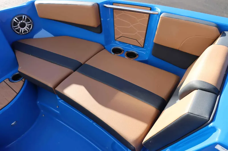 Slide: The Image of 2025 Yamaha Boats 222XD interior with brown and black seating, blue accents, and cup holders. - 20