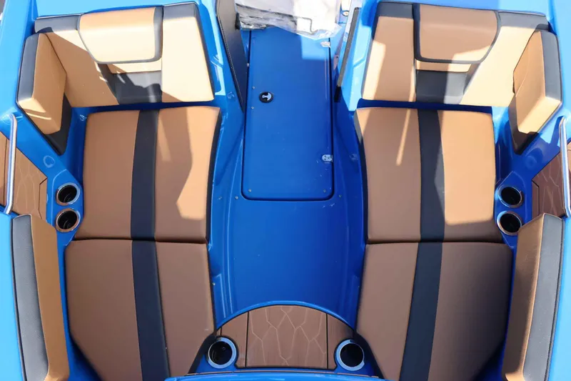 Slide: The Image of 2025 Yamaha Boats 222XD interior with tan and black seating, blue accents, and cup holders. - 23