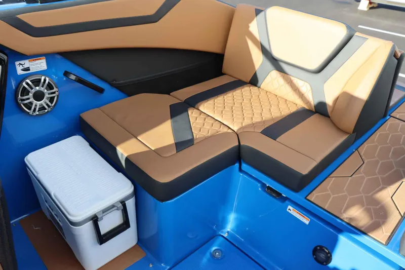 Slide: The Image of 2025 Yamaha Boats 222XD interior with tan and black seating, blue accents, and a white cooler. - 26