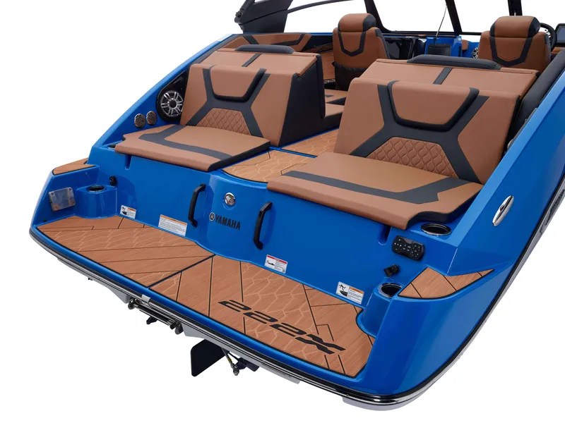 Slide: The Image of 2025 Yamaha Boats 222XD, blue and tan interior, luxury seating and deck design. - 37