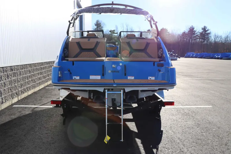 Slide: The Image of 2025 Yamaha Boats 222XD, blue exterior, parked on trailer, rear view. - 4