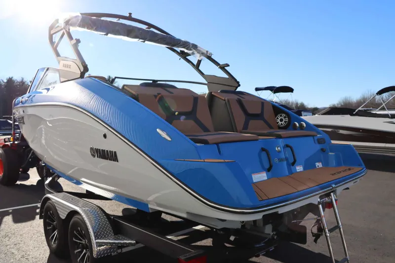Slide: The Image of 2025 Yamaha Boats 222XD in blue, displayed on a trailer under clear skies. - 5