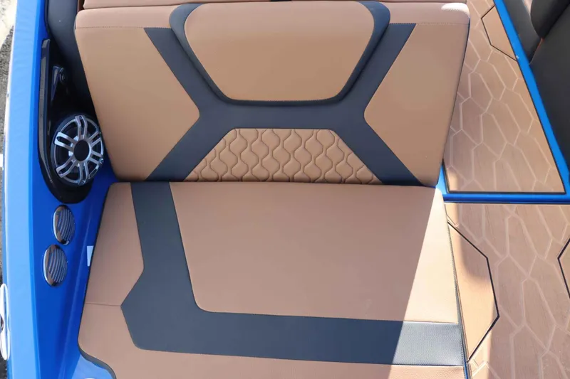 Slide: The Image of 2025 Yamaha Boats 222XD interior with tan and black seating, blue accents, and speaker system. - 7