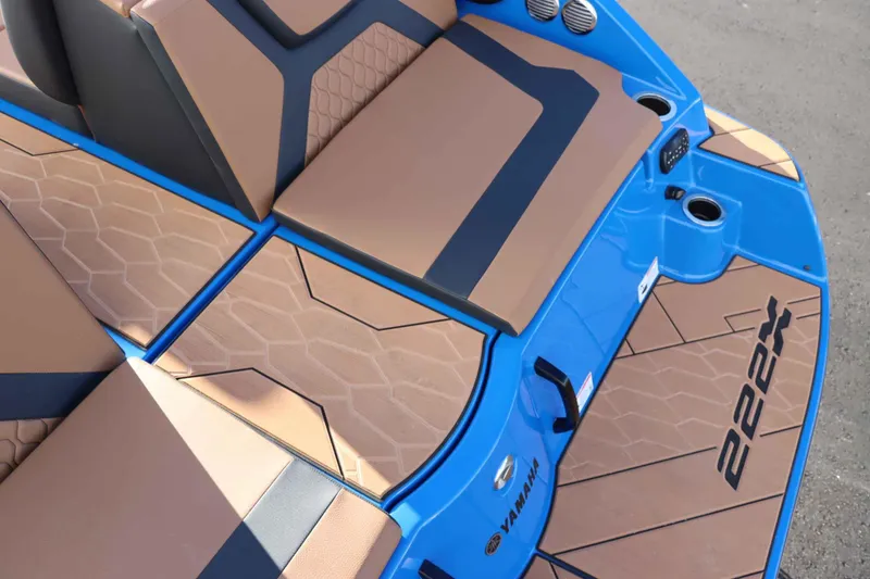 Slide: The Image of 2025 Yamaha Boats 222XD interior with tan and blue seating, modern design. - 8