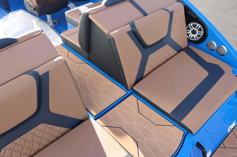 Slide: The Image of 2025 Yamaha Boats 222XD interior with tan and black seating, blue accents, and speaker system. - 9