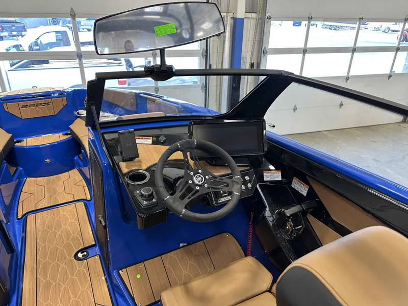 Slide: The Image of 2025 Yamaha Boats 222XE interior with steering wheel and dashboard, featuring modern design. - 13