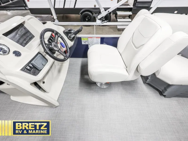 Slide: The Image of Vista Fish 18 boat interior with steering console and white seating, 2025 model. - 11