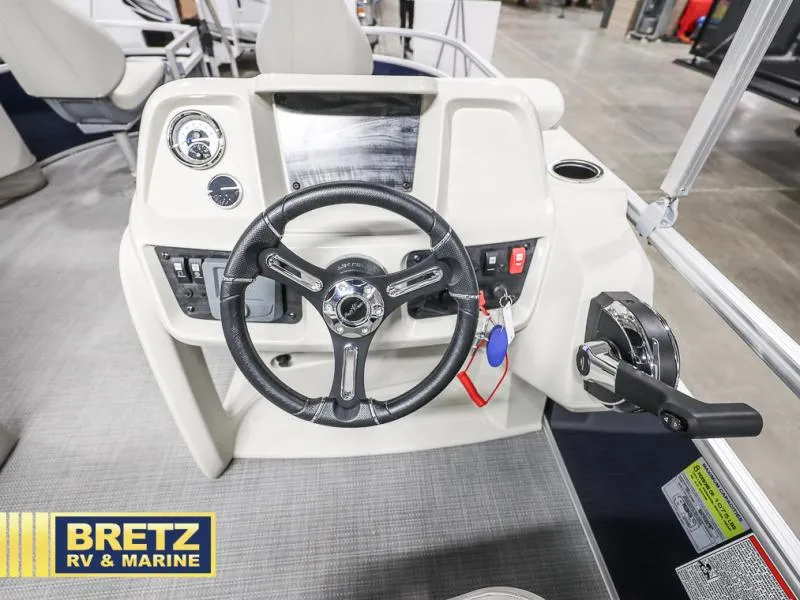 Slide: The Image of Vista Fish 18 boat dashboard with steering wheel and controls, 2025 model. - 12