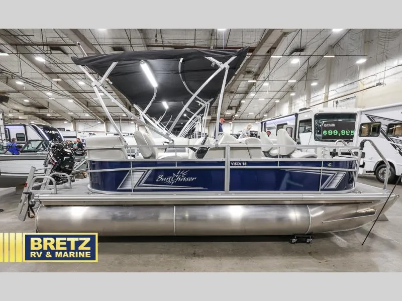 Slide: The Image of 2025 Vista Fish 18 pontoon boat displayed indoors at Bretz RV & Marine showroom. - 8