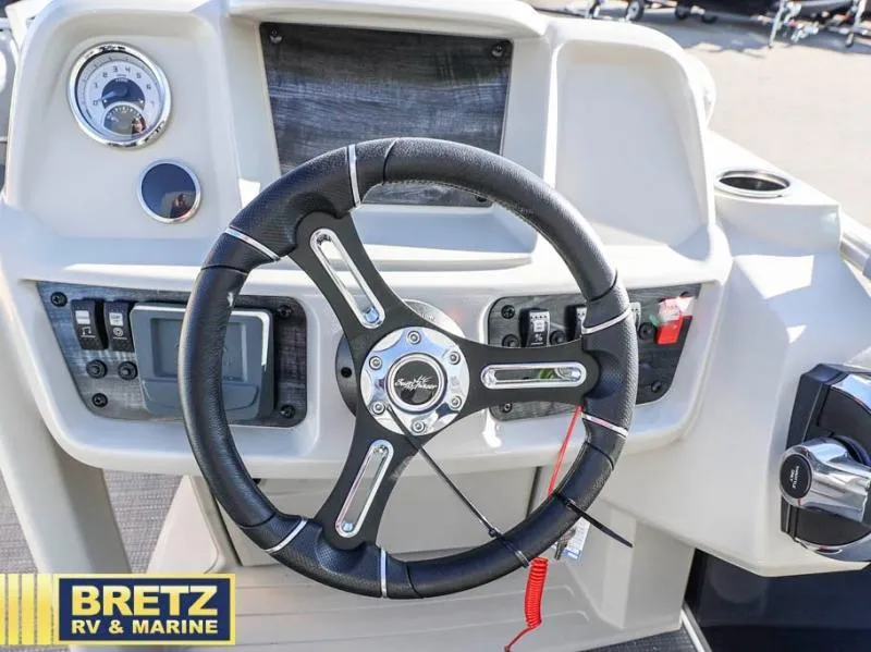 Slide: The Image of 2025 Vista Fish 18 boat dashboard with steering wheel and controls. - 9