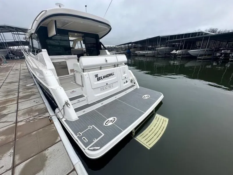 Slide: The Image of 2020 Regal 38 Grande Coupe yacht docked at marina, rear view. - 2