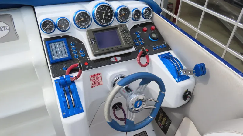 Slide: The Image of 2007 Cigarette 38 Top Gun boat dashboard with blue accents and navigation instruments. - 15