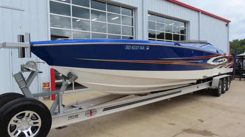 Slide: The Image of 2007 Cigarette 38 Top Gun speedboat on trailer, blue and white design. - 2