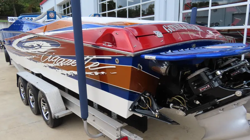 Slide: The Image of 2007 Cigarette 38 Top Gun speedboat on trailer, vibrant colors, powerful engine. - 3