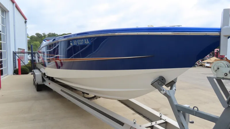 Slide: The Image of 2007 Cigarette 38 Top Gun boat on trailer, blue and white design. - 5
