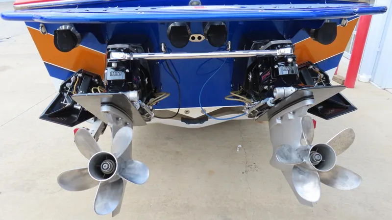 Slide: The Image of 2007 Cigarette 38 Top Gun boat with dual propellers and vibrant blue-orange design. - 7