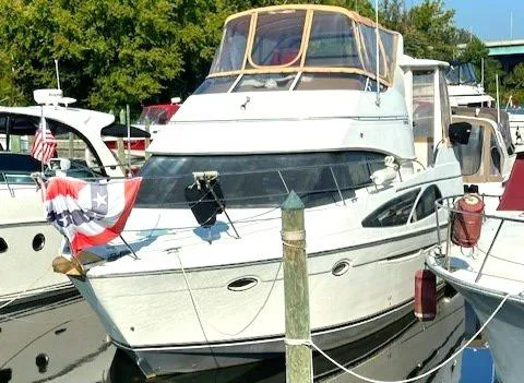 Slide: The Image of 2005 Carver 366 Motor Yacht docked at marina, decorated with patriotic bunting. - 1